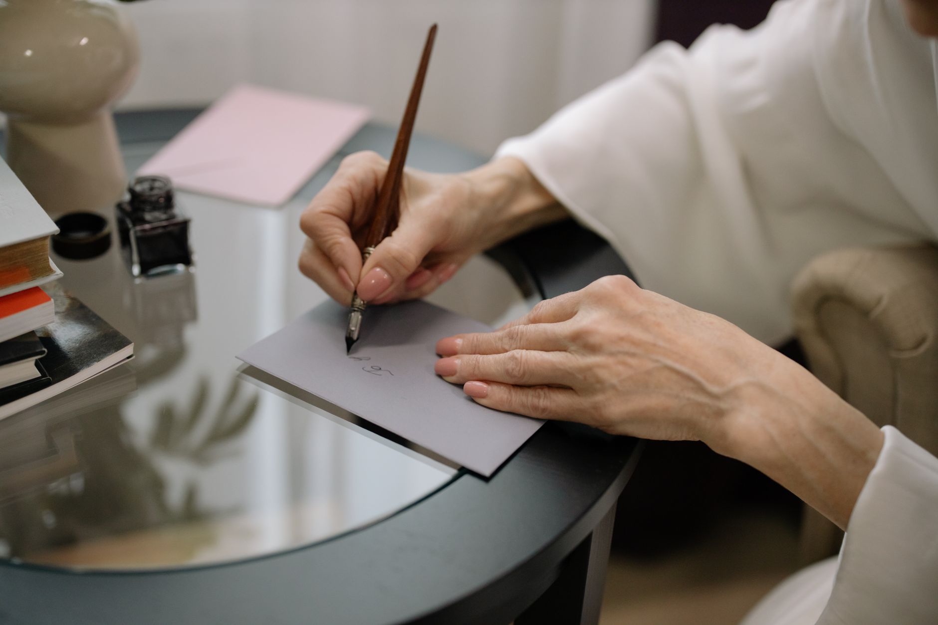 A real estate agent writing a handwritten note to a past client